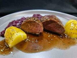 roasted duck with red  cabbage and potatoes photo