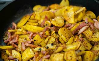 roasted potatoes with bacon onions and spices photo