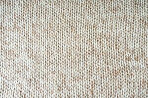 White biege melange knitting wool texture background. photo