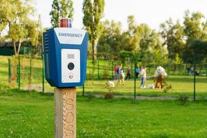 Panic alarm, police, emergency button in the public park. photo