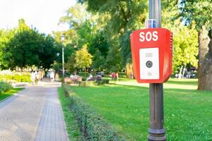 SOS, police, emergency button in the public park. photo