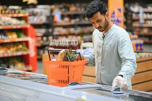 Man at grocery store products photo