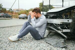 Car accident. Man after car accident. Man regrets damage caused during car wreck photo