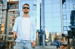 Blind man. Visually impaired man with walking stick, photo