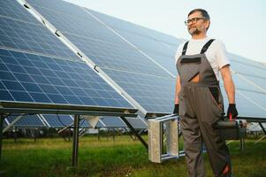 Worker installing solar panels outdoors photo