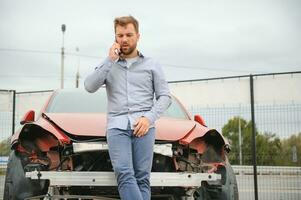 Man calling help after a car crash accident on the road photo