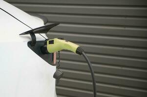 Electric cars charged on a charging station photo