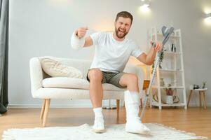 Happy man recovery from accident fracture broken bone injury with leg and arm. Social security and health insurance concept photo