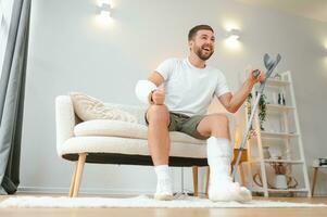 Happy man recovery from accident fracture broken bone injury with leg and arm. Social security and health insurance concept photo