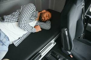 Truck driver enjoying comfortable cabin bed inside his truck photo