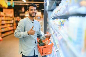 portrait of indian male in grocery with positive attitude photo