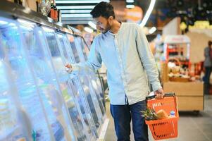 portrait of indian male in grocery with positive attitude photo