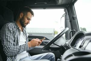 Truck driver sitting in cab photo