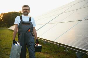 Worker installing solar panels outdoors photo