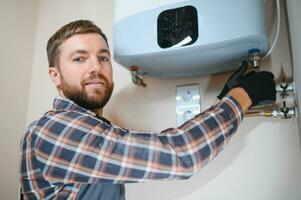 worker set up central gas heating boiler at home photo