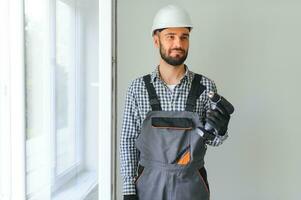 Construction worker installing window in house. photo