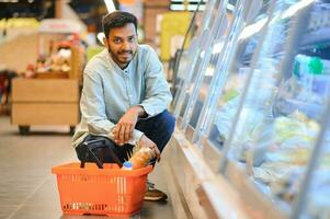 portrait of indian male in grocery with positive attitude photo