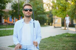 Blind man with a walking stick. photo