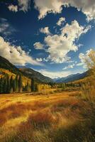 ai generado asombroso otoño escena con dorado campos, lozano verde bosques debajo un vibrante azul cielo adornado con mullido blanco nubes y un majestuoso montaña rango en el distancia. foto