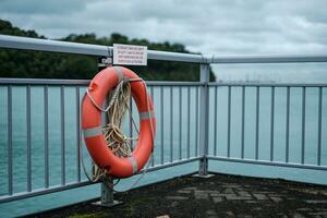 Orange Lifebuoy on Ocean Barricade photo