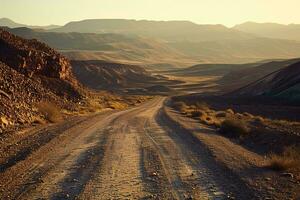 AI generated A tranquil scene of a winding desert road amidst vast, rolling mountains under the gentle embrace of a golden sunset. photo