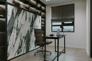 minimalist home office with sleek black desk and chair photo