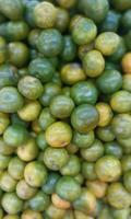 orange Fresh ripe juicy limes as background photo