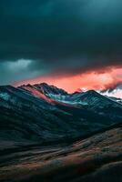 AI generated A breathtaking scene capturing the moment when the sunset illuminates mountain peaks under a dark cloudy sky, showcasing nature's dramatic and serene beauty. photo