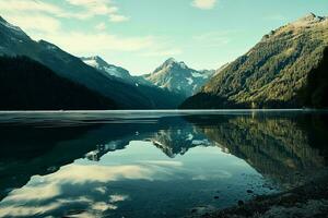 ai generado asombroso ver de un tranquilo alpino lago reflejando imponente, besado por la nieve montañas rodeado por denso, verde bosques debajo un claro cielo foto