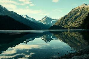 AI generated Breathtaking view of a tranquil alpine lake reflecting towering, snow-kissed mountains surrounded by dense, green forests under a clear sky photo