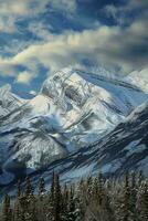 AI generated a breathtaking view of snow-covered mountains with towering peaks rising majestically against a clear blue sky. A tranquil lake is nestled amidst these mountains photo