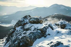 AI generated A breathtaking view of snow-covered mountains with a rocky terrain in the foreground under the soft glow of sunlight. photo