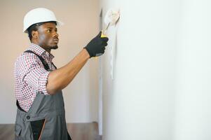 young male electrician install electrical outlets and switch photo