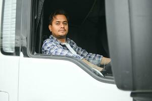 Young Indian truck driver. Concept of road freight transportation photo