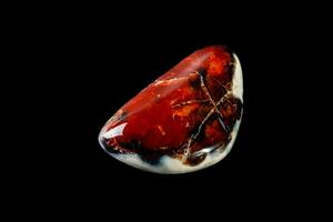 Macro mineral stone Cornelian on a black background photo