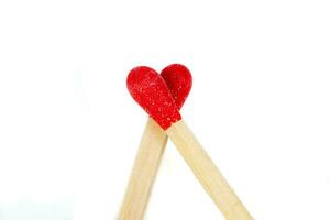 matchstick with a red heart-shaped head on a white background photo