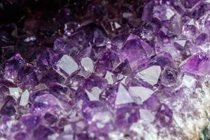 Macro Mineral Stone Amethysts in the rock on a white background photo