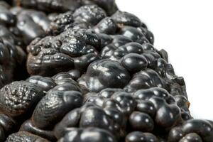 Macro mineral Hematite stone on a white background close-up photo