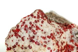 Macro stone mineral Cinnabar on a white background photo