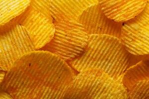 macro of beautiful corrugated yellow chips under the sun's rays photo