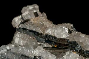 Macro mineral stone Stibnite quartz on a black background photo