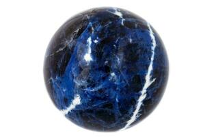 Macro mineral stone Sodalite ball on white background photo