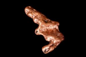 Macro mineral stone of a copper nugget on a microcline on a black background photo