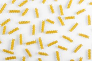 Pasta products in the form of a spiral, texture, on a white background photo