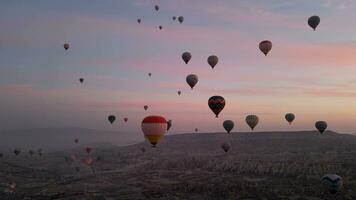 Hot air balloon flight in Goreme in Turkey during sunrise. Ride in a hot air balloon, the most popular activity in Cappadocia. Romantic and famous travel destination. video