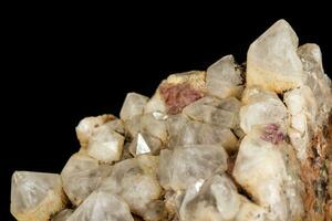 Macro mineral quartz stone with fluorite on granite on a black background photo