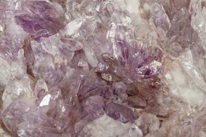 Macro of amethyst mineral stone on black background photo