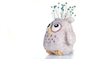 pincushion in the form of an owl on a white background photo