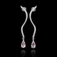 Beautiful earrings with diamonds and morganite on a black background photo