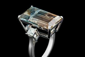 beautiful gold ring with topaz gemstones on a black background photo